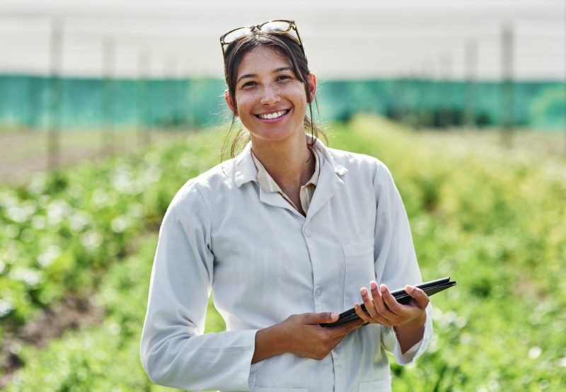 Portrait, tablet and agriculture with a woman in a greenhouse on a farm for organic sustainability. Food, spring and a female farmer outdoor to manage fresh vegetables or produce crops for harvest.